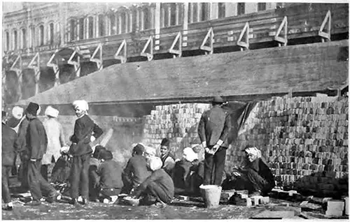 Hindu Immigrants Preparing a Meal on CPR Wharf at Victoria, BC.