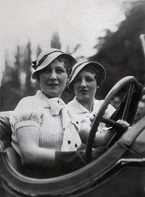 Two Women in Their Motorcar Display the Latest Fashions from Paris.