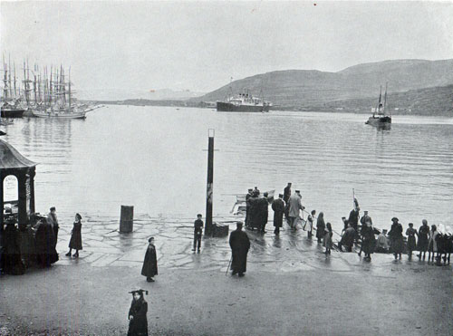 Photo 066: At the Quai in Hammerfest; Passengers embark on the tendor heading for the Steamship anchored in the Harbor.