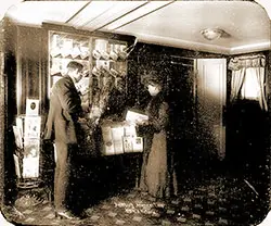 Passengers Browse the Brochure Kiosk on Board the SS Victoria. Glass Plate Image Circa 1900.