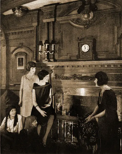 Women Gather Around the Fireplace for a Firelight Chat in the Drawing Room.