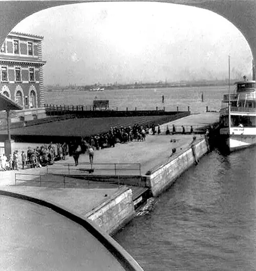 Boat Unloading Immigrants at Ellis Island, New York Harbor.