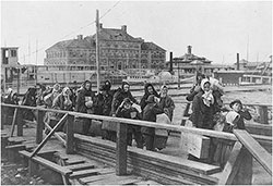 Tender Brings New Immigrants to Landing at Ellis Island.