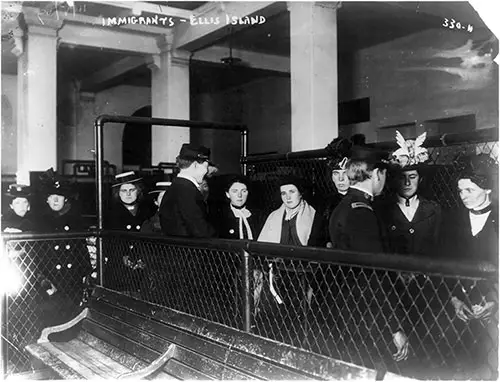 Immigrants Pass By Inspectors at Ellis Island circa 1910s.