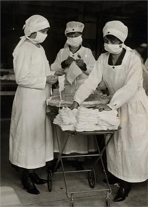 Red Cross Workers of Boston Busily Engaged in Making Protective Masks While One is Removing Bundles of Masks for American Soldiers circa 1918.