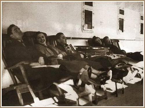 Passengers Relax On Comfortable Deck Chairs