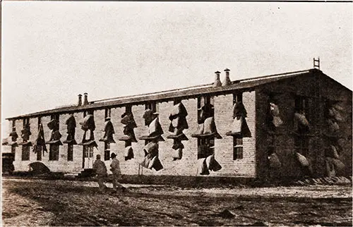 Blankets and Mattresses Are Suspended Out the Barrack Windows of the 302nd Light Artillery During Morning Drill.