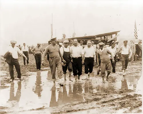 Members of the "Bonus Expeditionary Force" Walking through the Muddy Streets of Camp Marks, Washington DC, 18 June 1932.